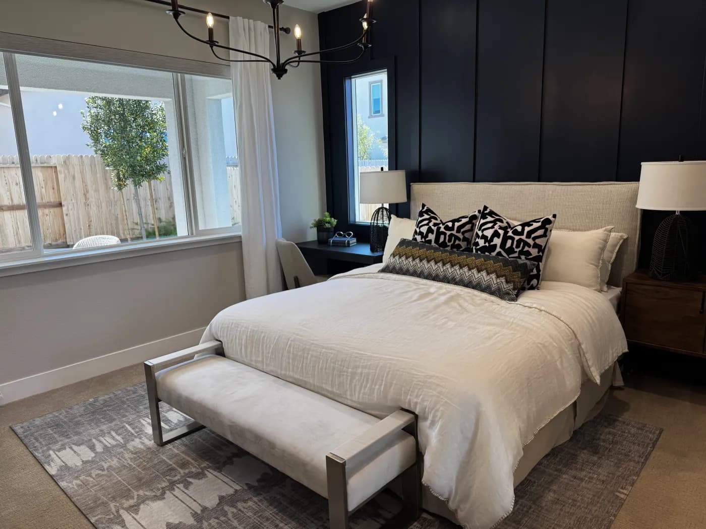 Bedroom at Amoruso Ranch with navy accent wall, king bed, and oversized window seat