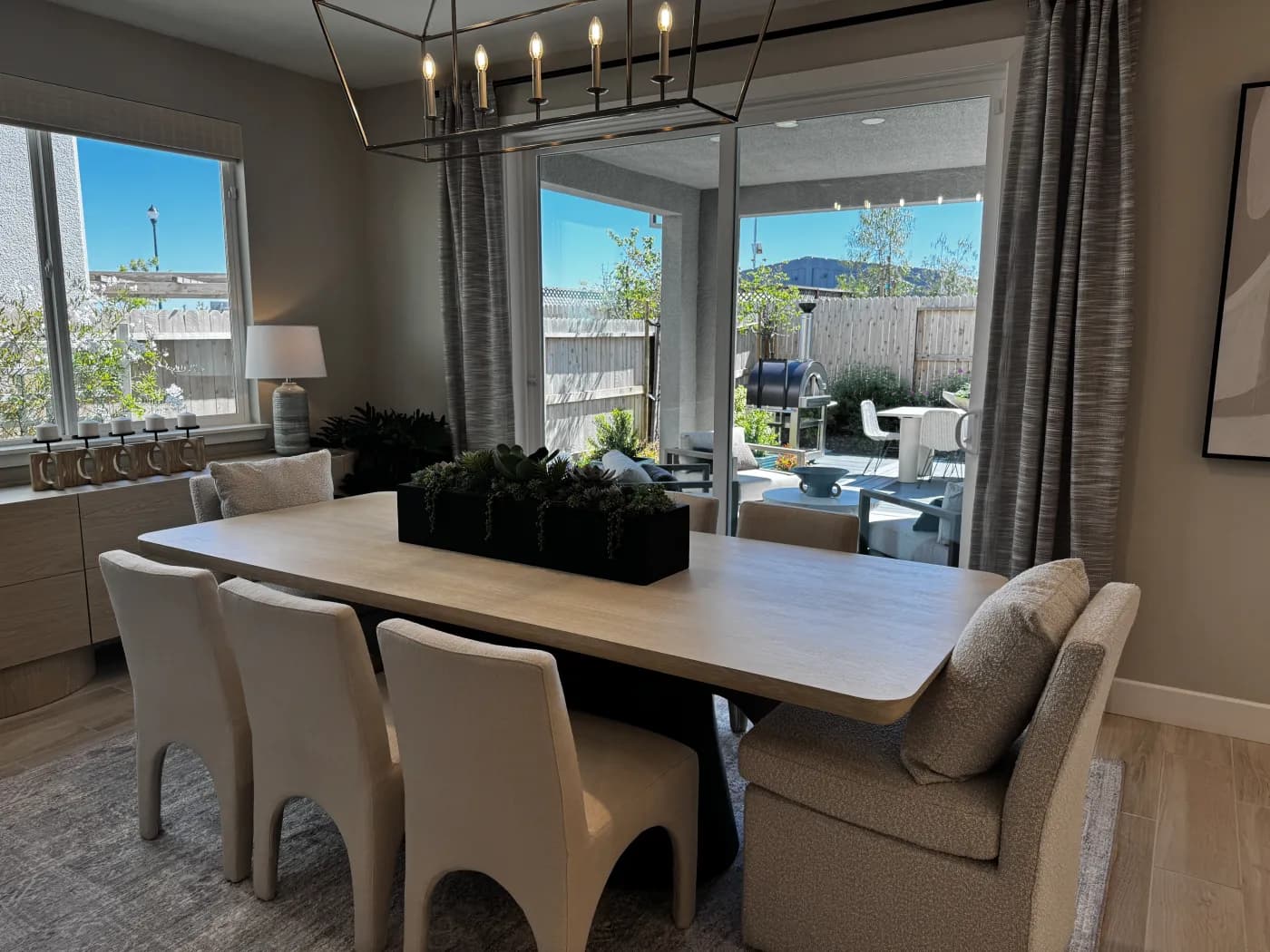 Dining room at Amoruso Ranch with linear chandelier and slider opening to the backyard
